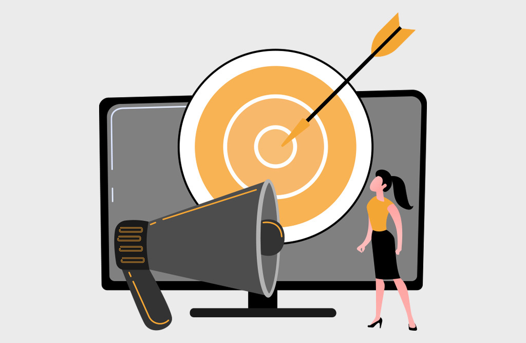 woman looking at animated megaphone and bullseye target in front of a desktop