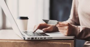A person ordering something online with their credit card.