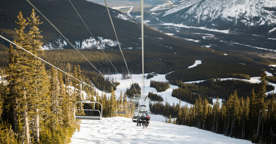 ski lift overlooking snow-capped mountain