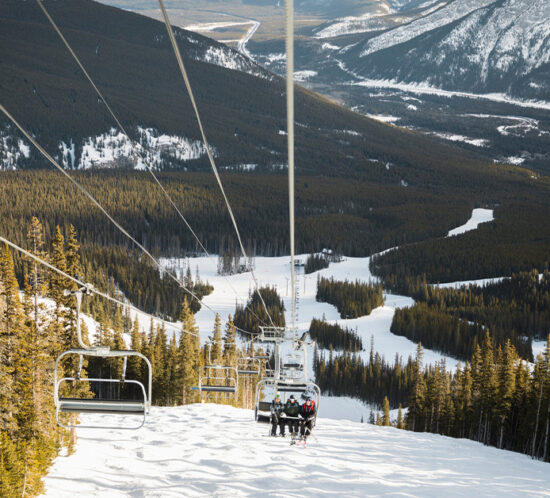 ski lift overlooking snow-capped mountain