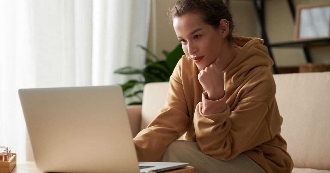 woman sitting at a desk looking at her computer