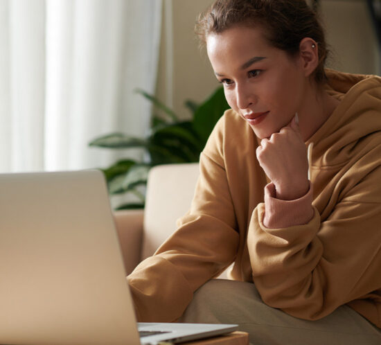 woman sitting at a desk looking at her computer